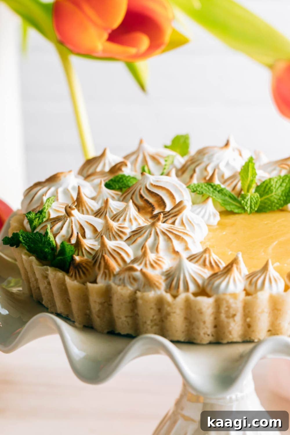 An elegant slice of Easy Lemon Meringue Tart, displaying its fluffy meringue peaks and bright lemon filling.
