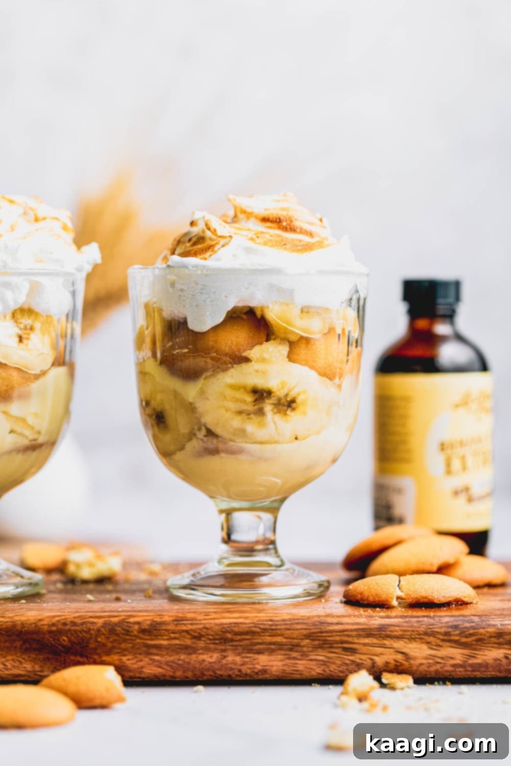 Homemade Southern Banana Pudding with a towering, fluffy meringue topping, showing layers of pudding, bananas, and wafers.