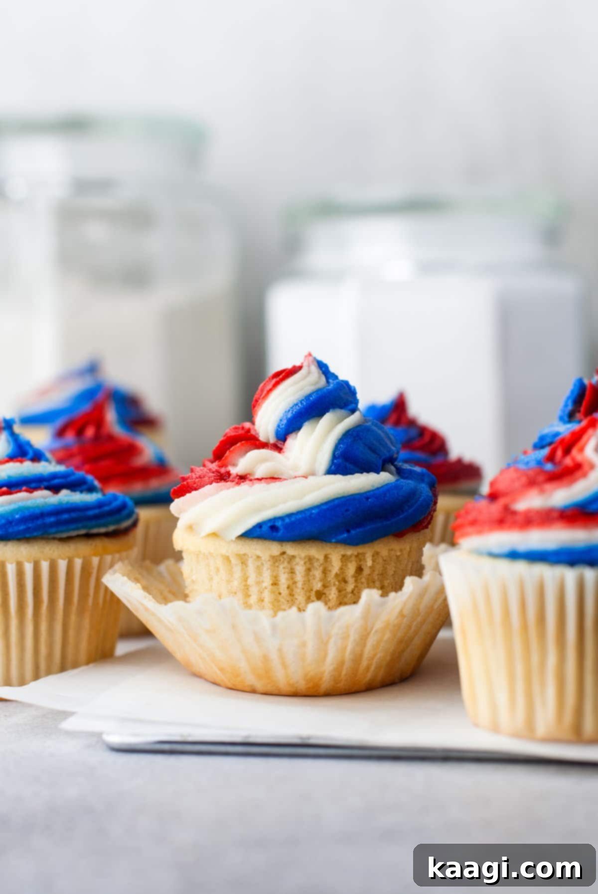 Red White and Blue Cupcakes topped with vibrant red, white, and blue buttercream frosting swirls.