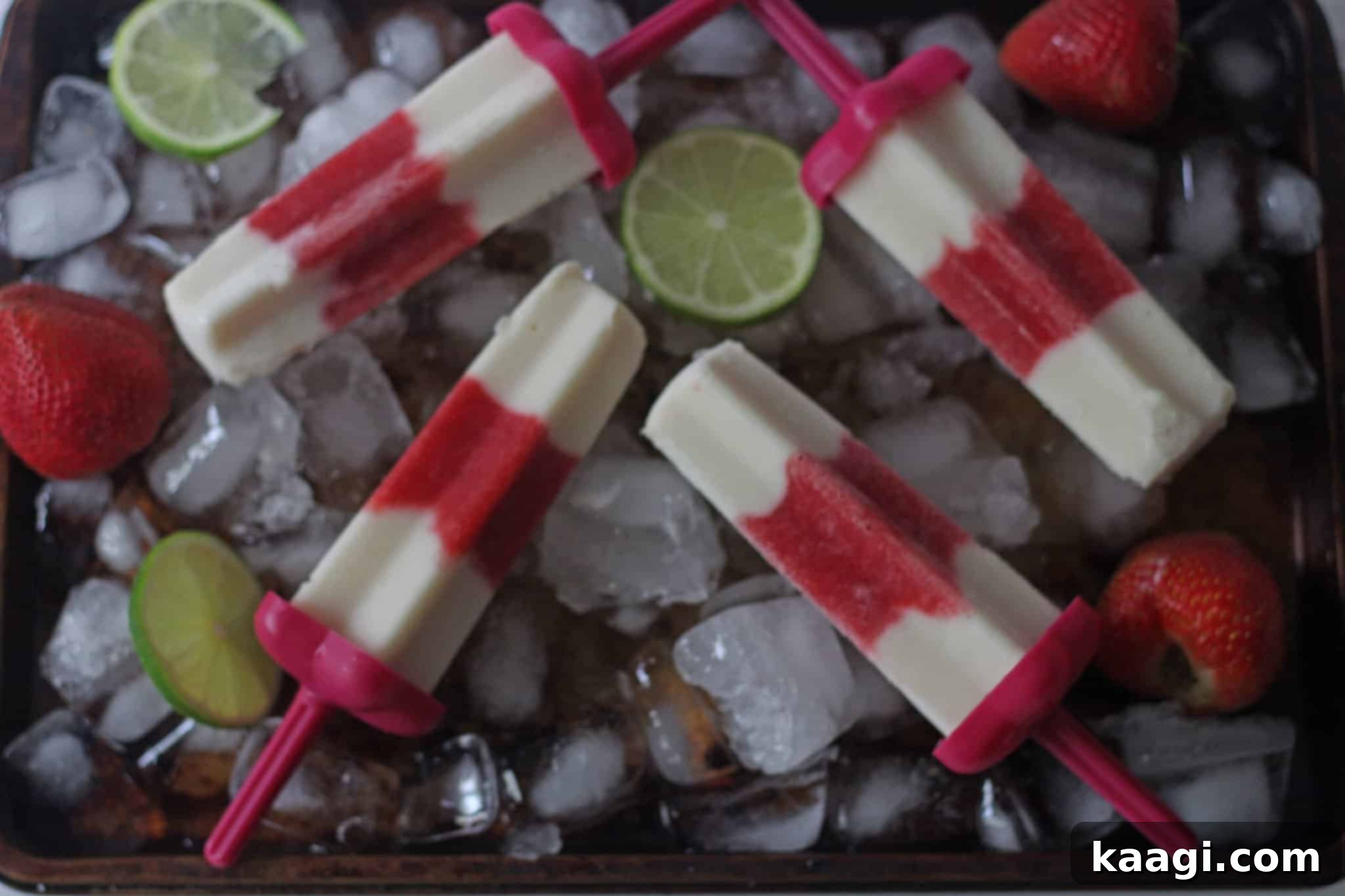 Refreshing Vanilla Strawberry Popsicles, showing their swirling red and white layers, ready to cool you down.