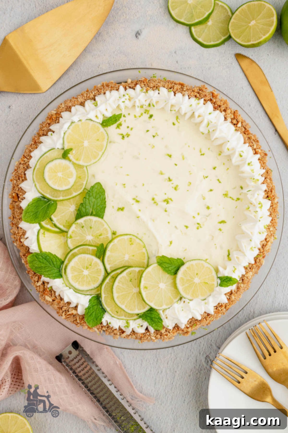 An overhead shot of a vibrant Key Lime Pie with thin slices of lime and a dollop of whipped cream on top, highlighting its tangy appeal.