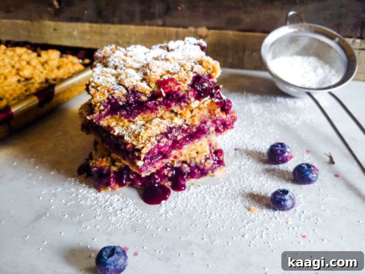 A large tray of Blueberry Crumble Bars, showcasing their golden crumb topping and juicy blueberry filling.