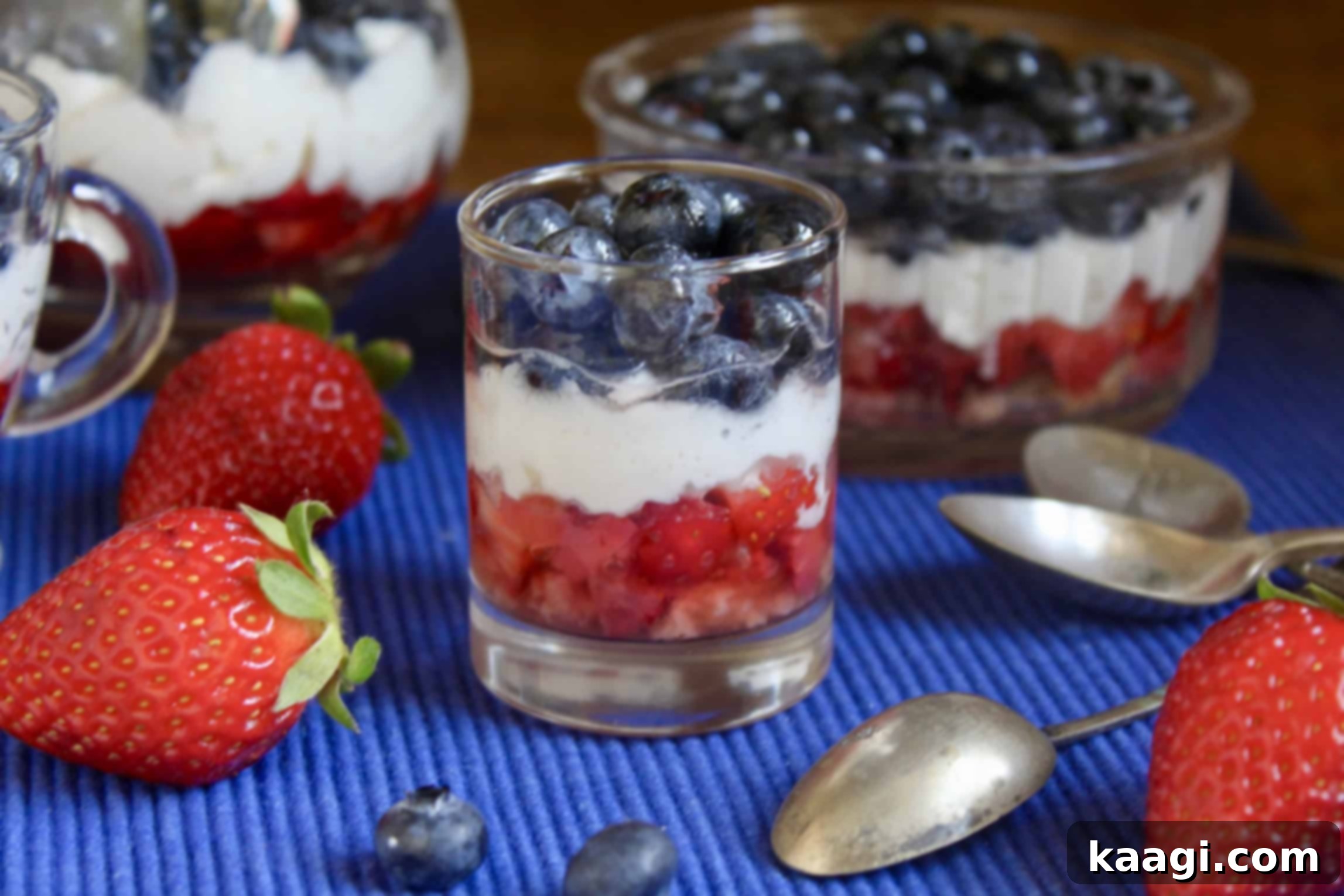 Red White and Blue Trifles (No Cooking, No Baking!) in individual clear glasses, showing fruit and cream layers.