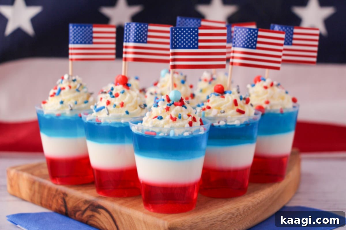 Red white and blue jello shots in individual cups, showing distinct layers.