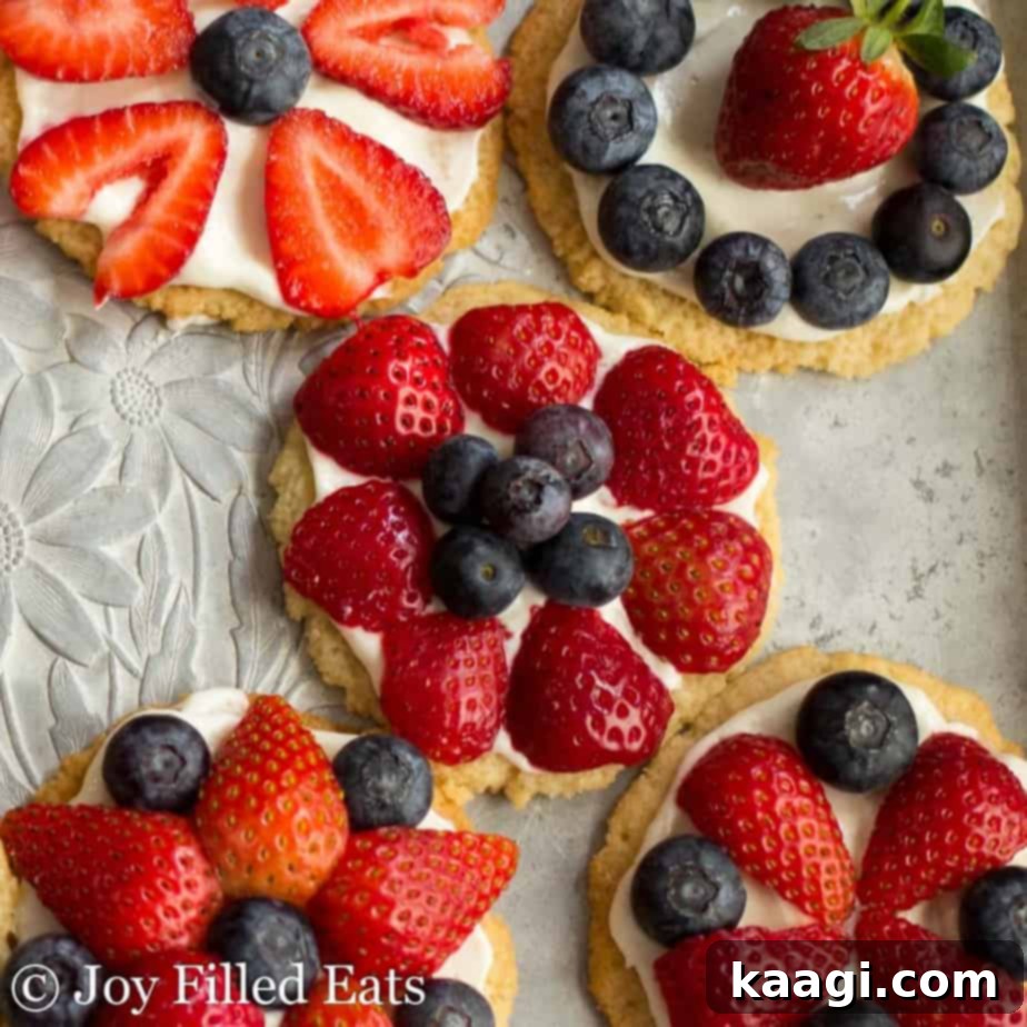 Healthy Fruit Pizza Cookies in red, white, and blue colors, topped with fresh fruit.