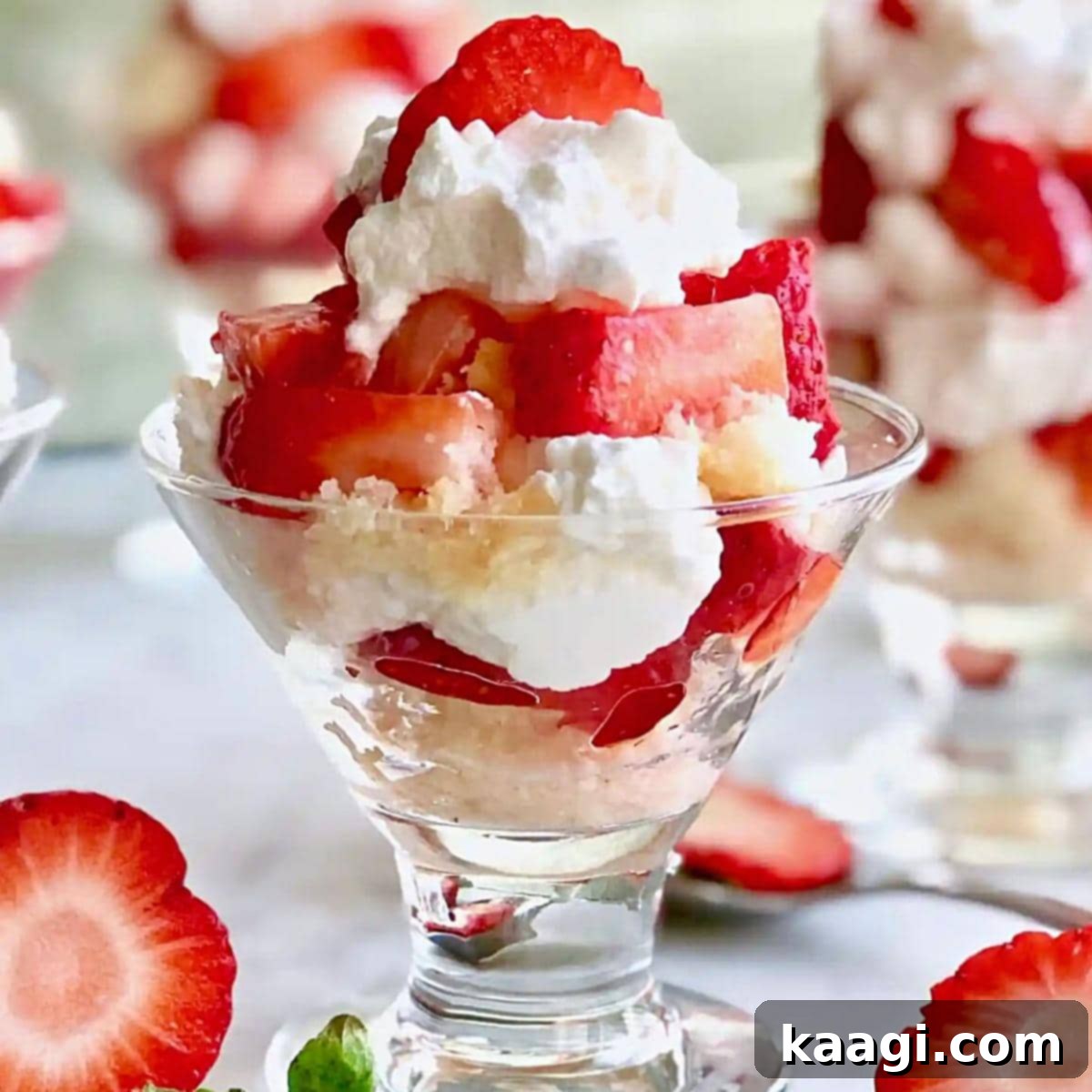 Mini Strawberry Shortcakes served in individual glasses, showcasing layers of cake, strawberries, and whipped cream.