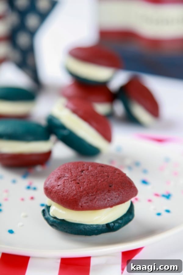 Red, White, and Blue Whoopie Pie Recipe, showing a sandwich of soft cake-like cookies and marshmallow frosting.