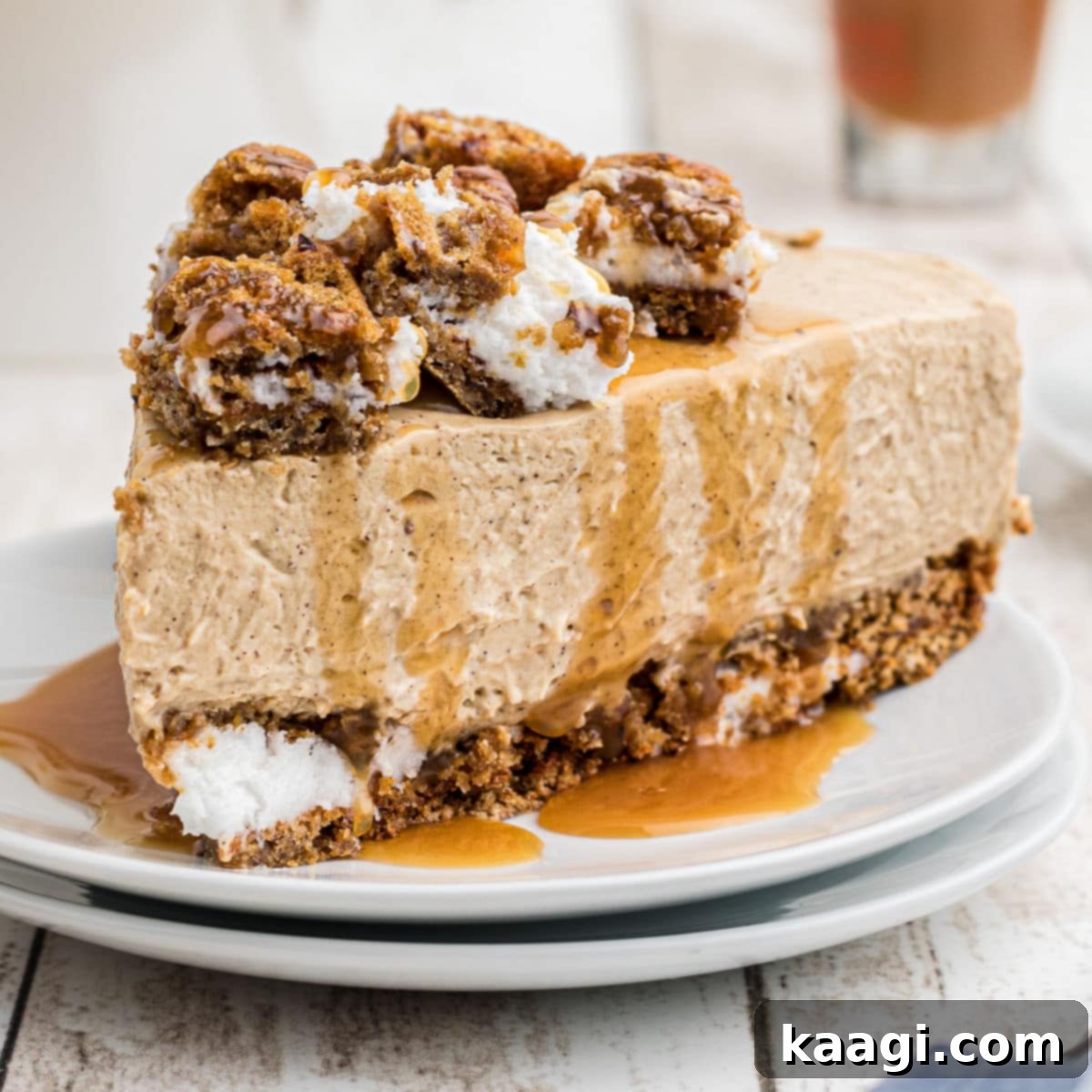 A perfectly cut slice of oatmeal creme pie cheesecake with caramel sauce drizzled on top, revealing its creamy layers.
