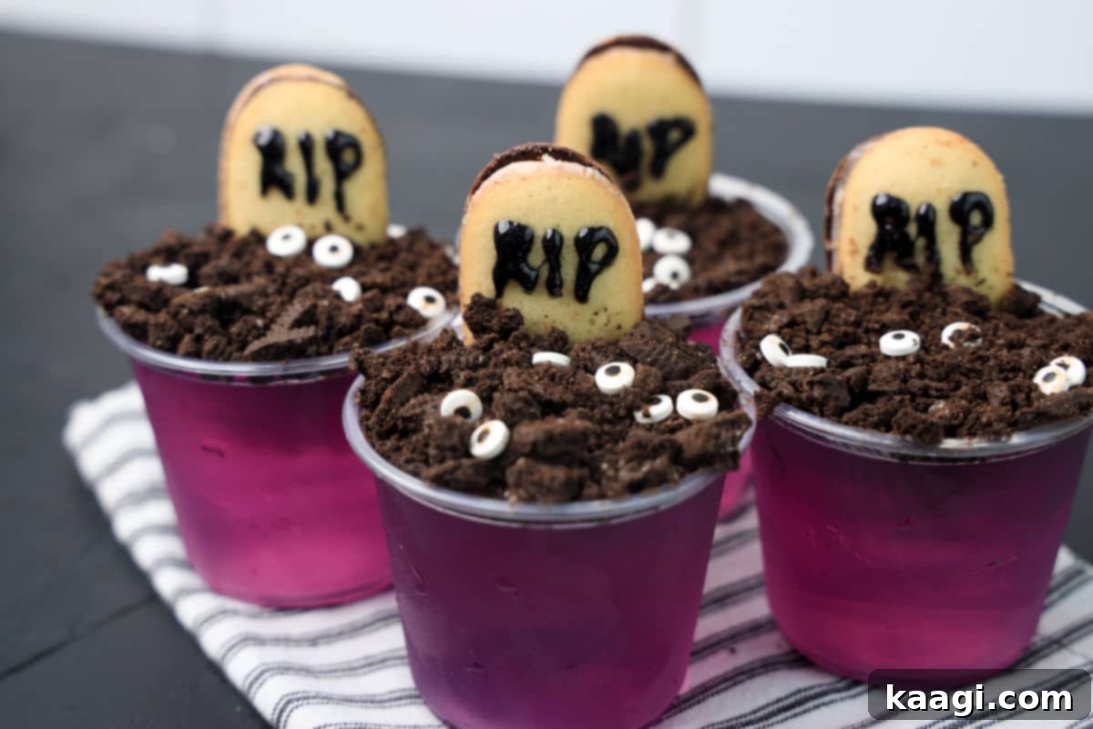Halloween Jello Shots with Rum, styled as Graveyard Jello Shots with cookie 'dirt'.