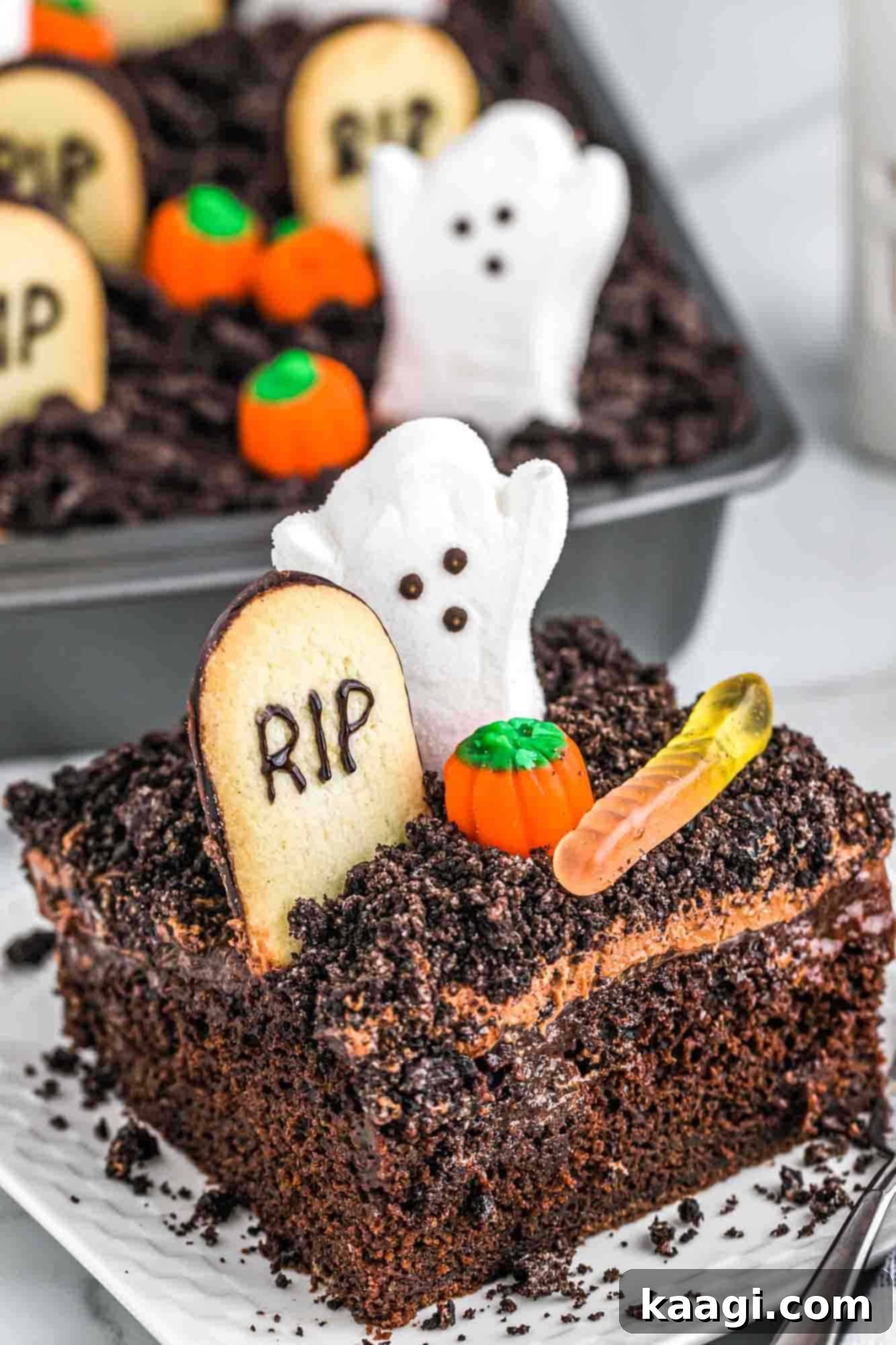 Halloween Graveyard Dirt Cake with crushed Oreos and spooky decorations.