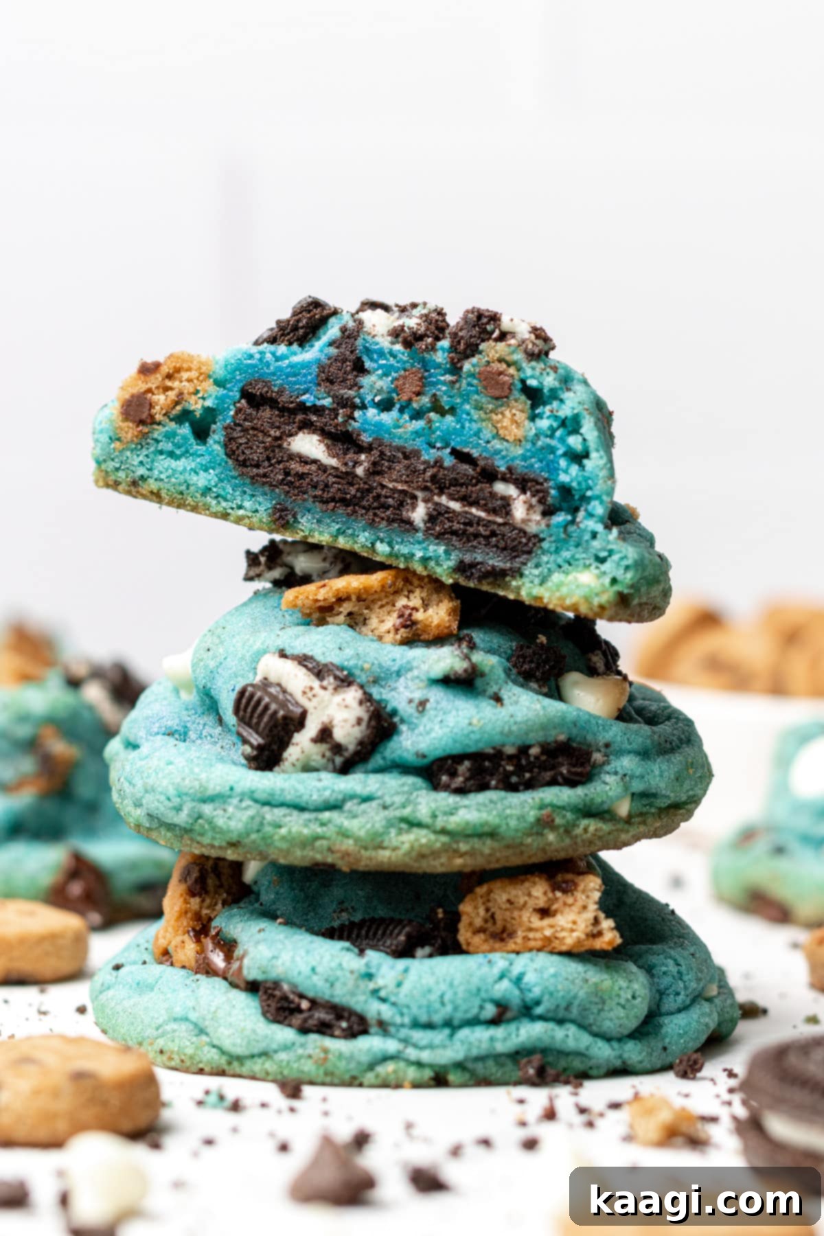 Bright blue Cookie Monster Cookies loaded with chocolate chips, cookie pieces, and an Oreo in the center.