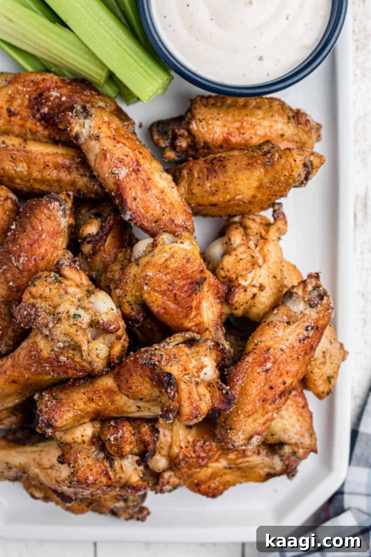 Crispy Air Fryer Ranch Wings 2 Overhead shot of some air fryer ranch chicken wings, close up, with some celery and dip, ready to be served.