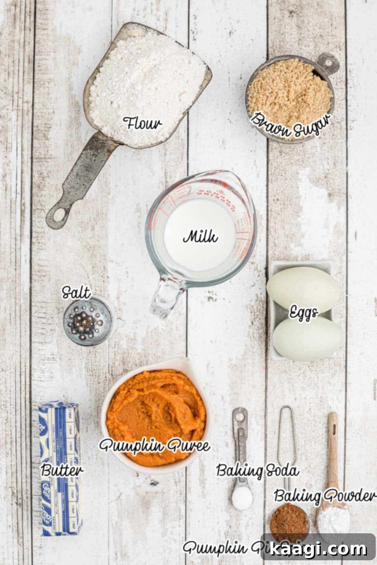 A beautifully arranged flat lay of all the essential dry and wet ingredients needed to bake delicious pumpkin spice donuts, including flour, sugar, spices, pumpkin puree, and eggs.