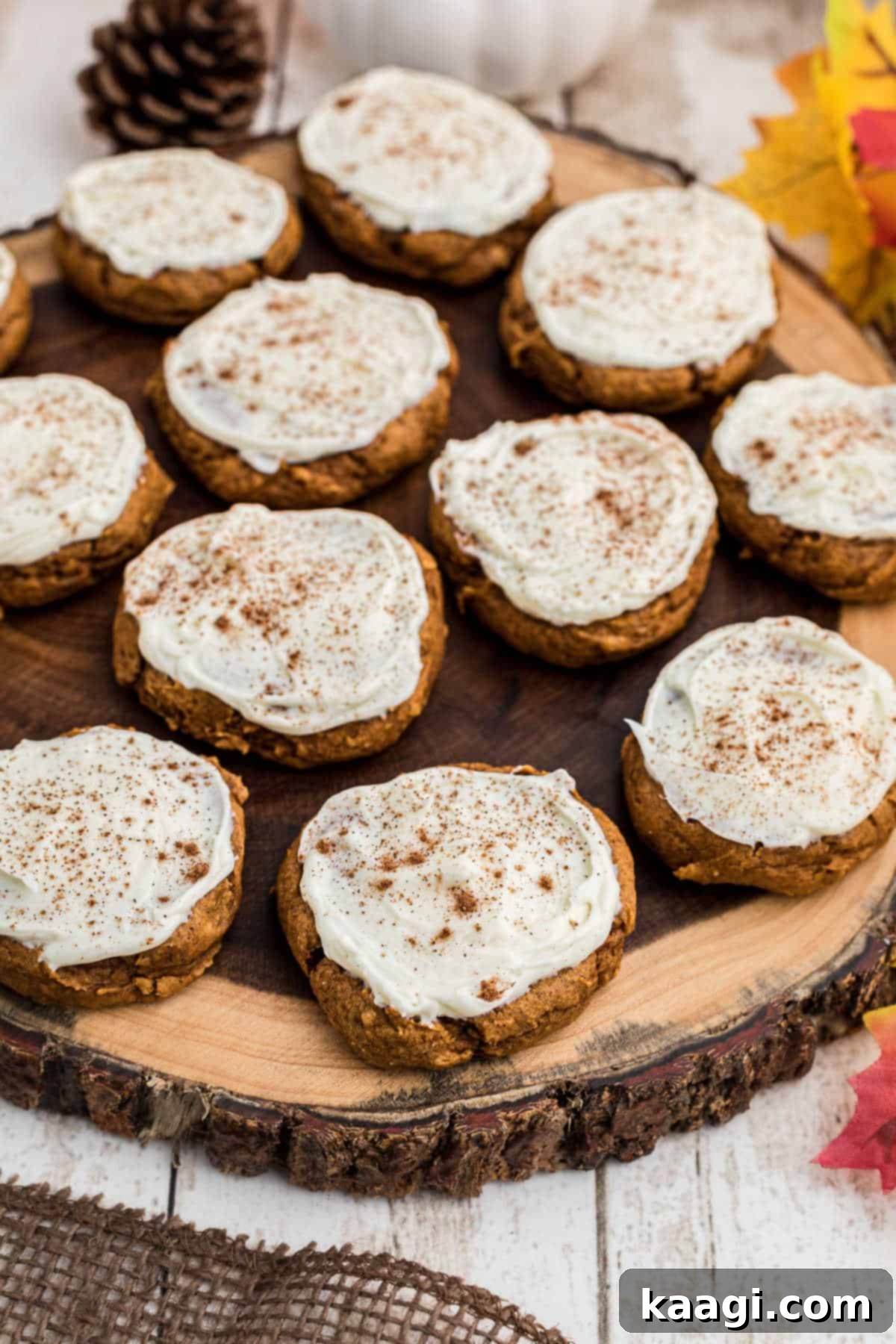 An inviting overhead shot of delicious pumpkin cookies arranged on a rustic wooden board, ready for serving.