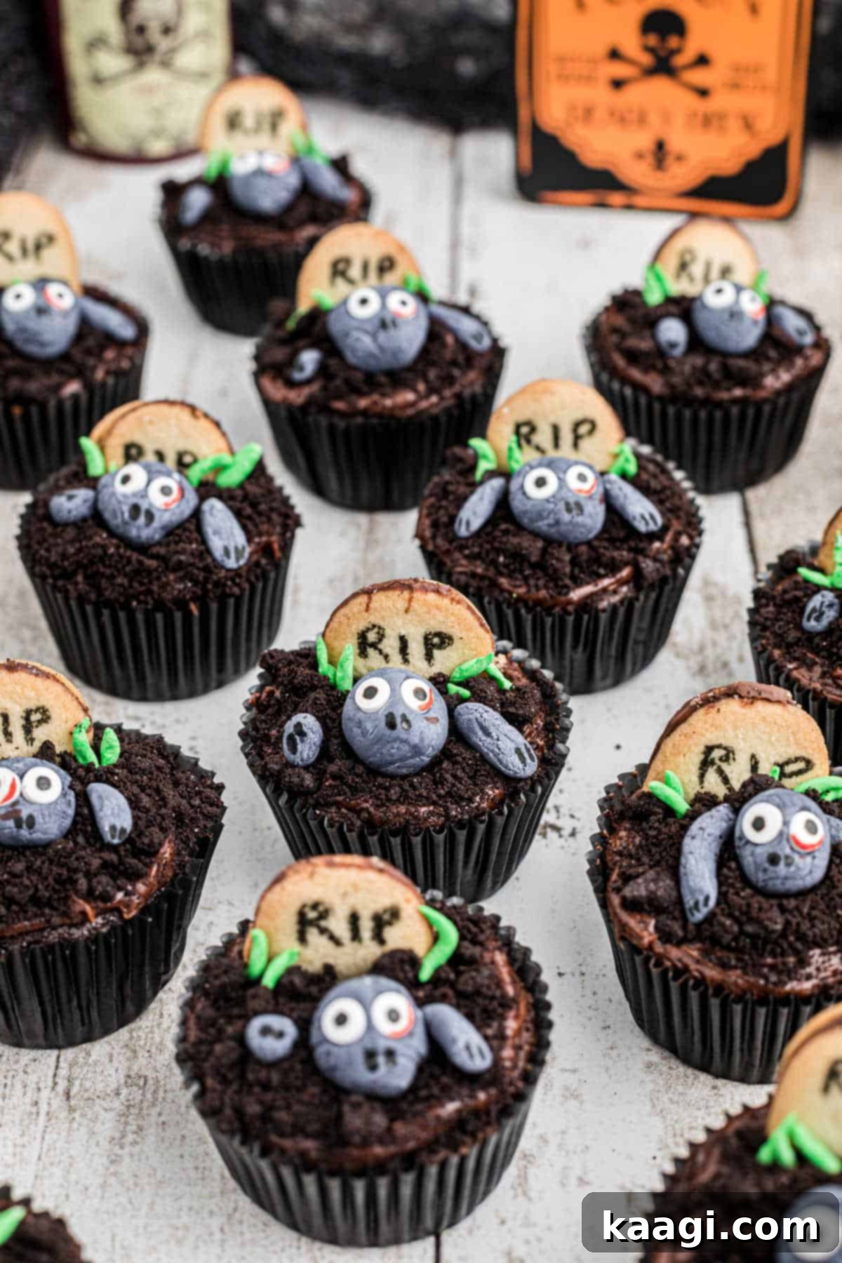 Overhead View of Zombie Cupcakes An overhead shot showcasing a platter of charmingly spooky zombie cupcakes, featuring fondant zombies, Oreo earth, and cookie gravestones.