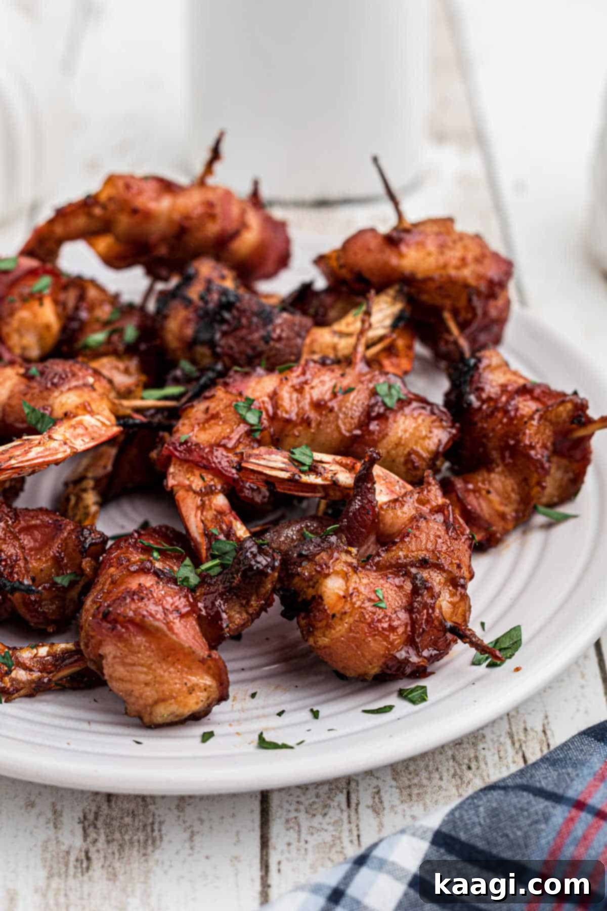 Close-up of a plate of freshly smoked bacon wrapped shrimp, garnished