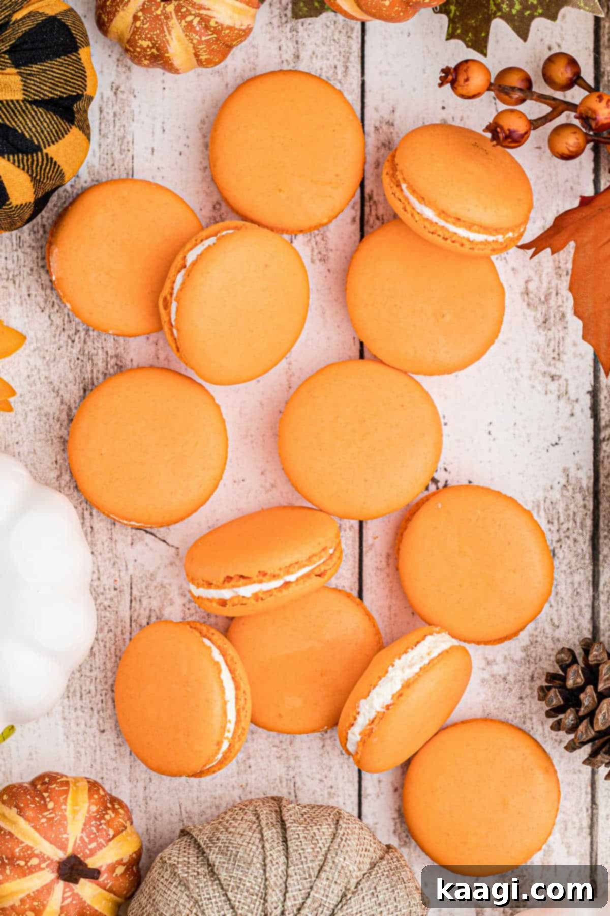 Harvest Pumpkin Macaron Bites 2 An overhead shot of pumpkin spice macarons elegantly laid out on a table, showcasing their delicate shells, signature 'feet', and creamy filling.