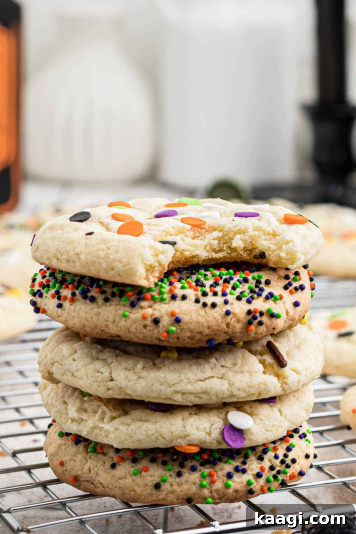 Spooktacular Sprinkled Cookies 5 A stack of golden brown Halloween cookies topped with festive sprinkles.