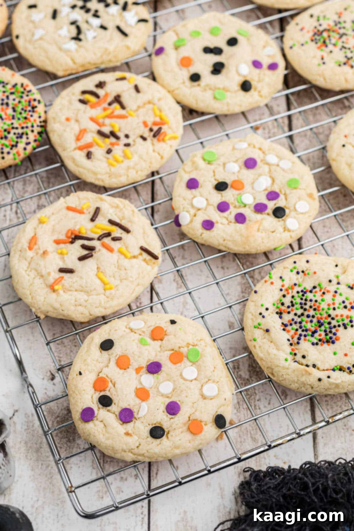 Spooktacular Sprinkled Cookies 6 Overhead shot of Halloween cake mix cookies cooling on a wire rack, covered in festive sprinkles.