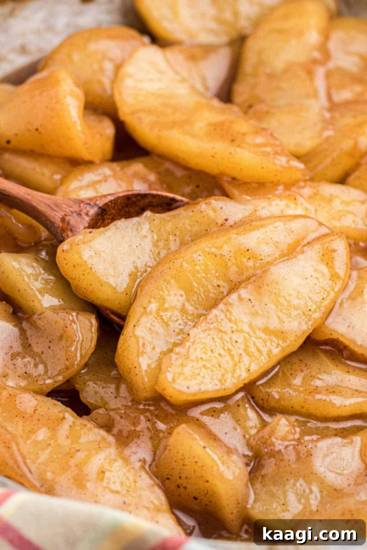 Close up shot of fried apples with a spoon digging in.