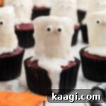 Fluffy Phantom Cupcakes 8 Close up of a ghost cupcake, showcasing its detailed decoration.