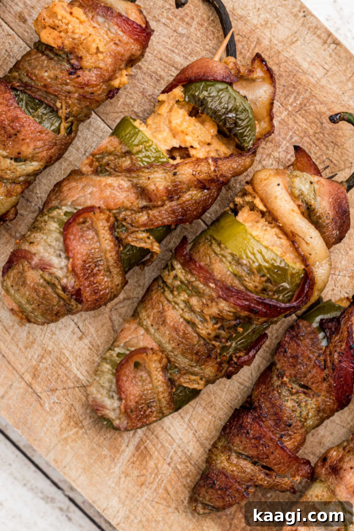 Fiery Smoked Jalapeno Bites 2 Stuffed jalapeno peppers, with cheese, and bacon wrapped around the outside, ready for smoking.