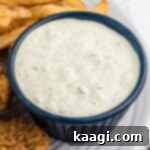 Close up of a dish of southern tartar sauce, garnished with fresh dill.