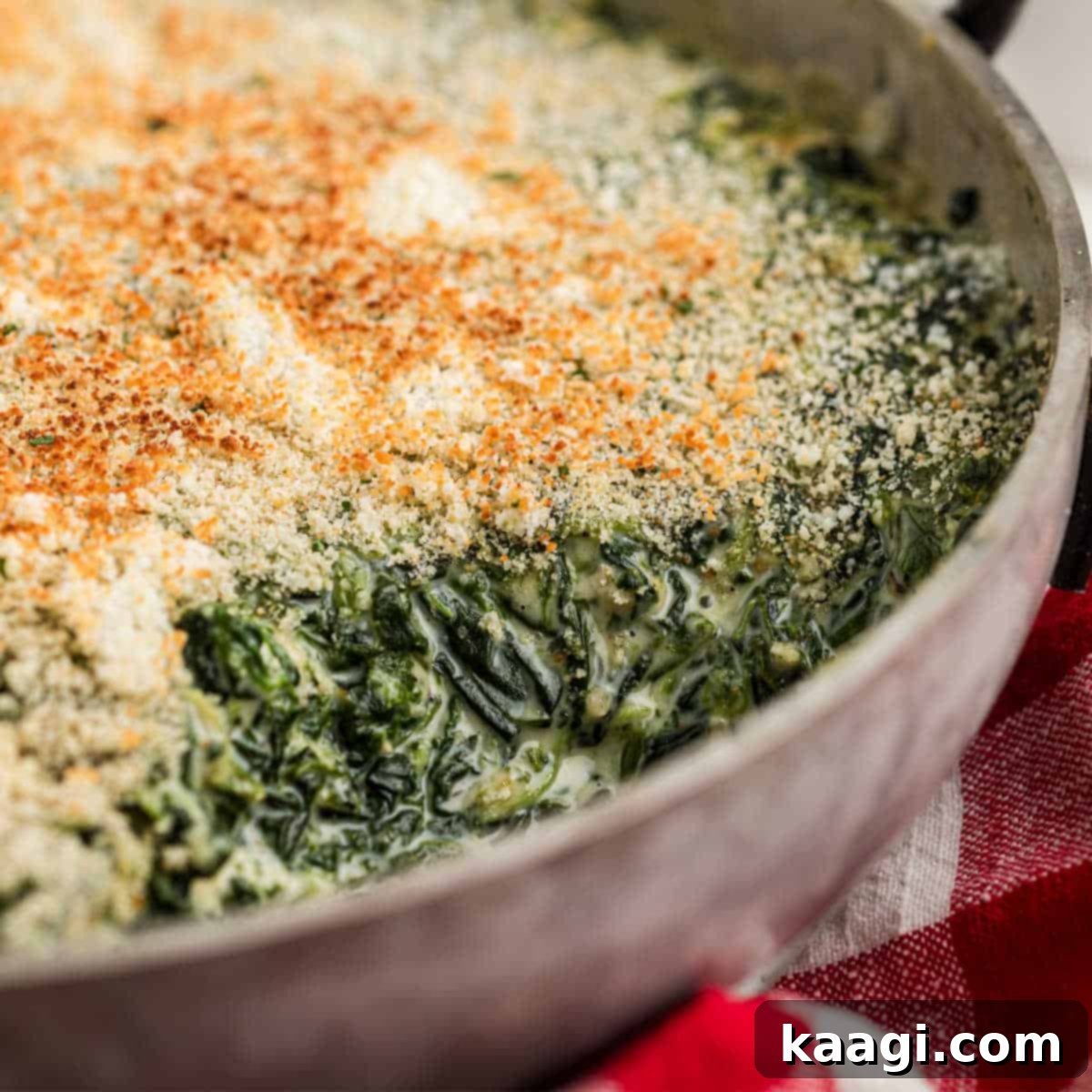 25 Must-Try Cajun Thanksgiving Side Dishes 4 Close up shot of a spinach madeleine dish in a pan with a scoop missing.