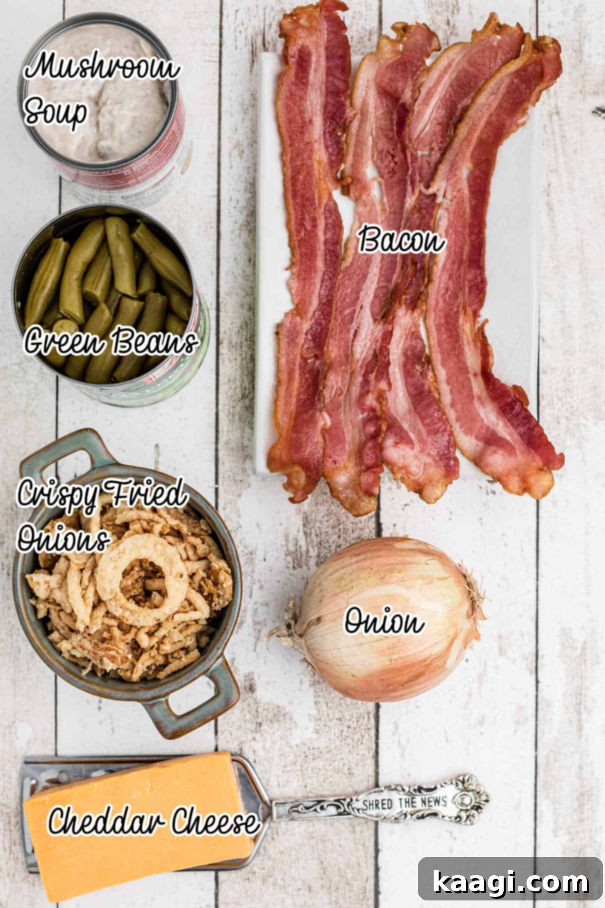 A collection of ingredients, including canned green beans, cream of mushroom soup, bacon, onions, cheddar cheese, and crispy fried onions, laid out for an air fryer green bean casserole.
