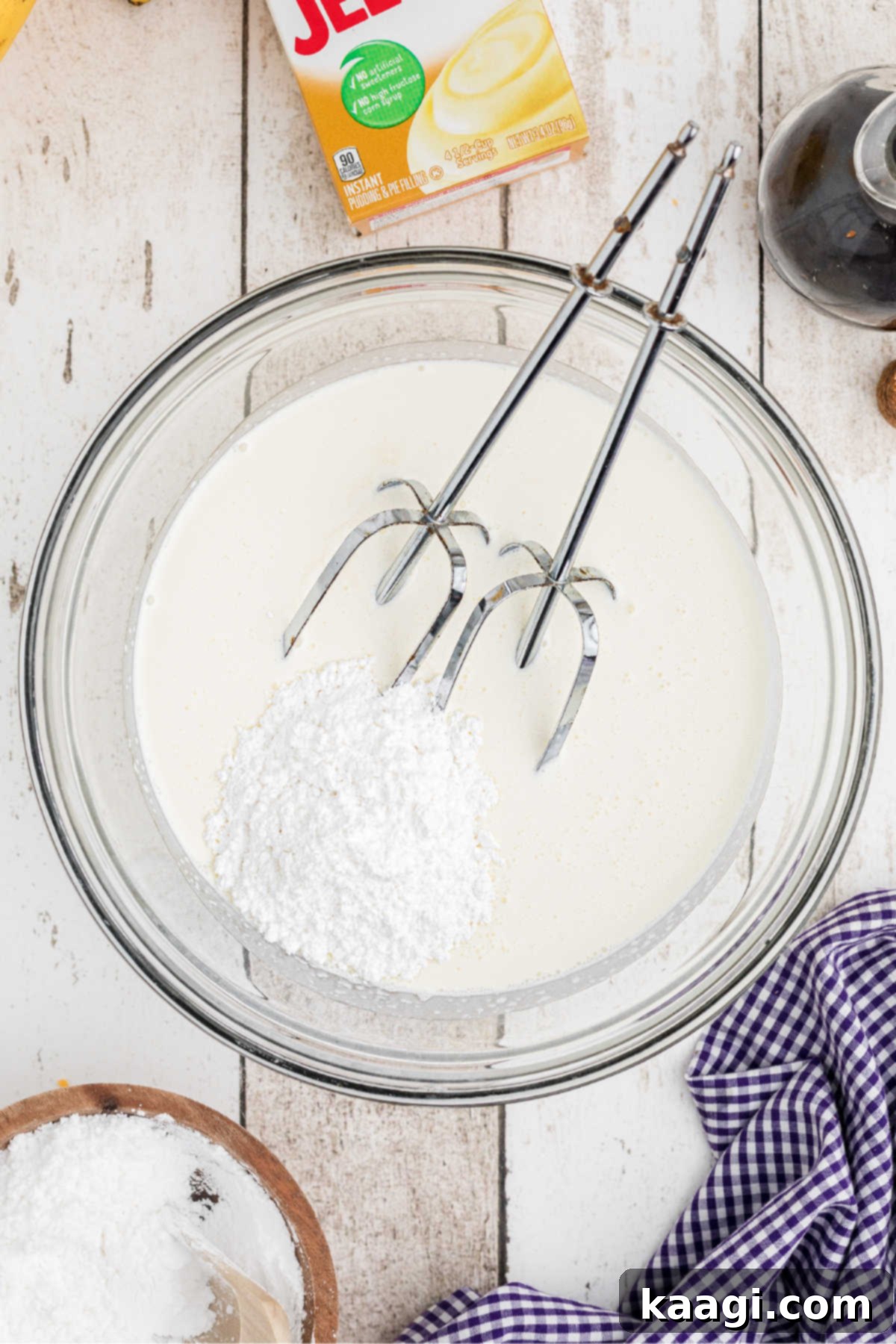 A large mixing bowl being used to whip up some cream.