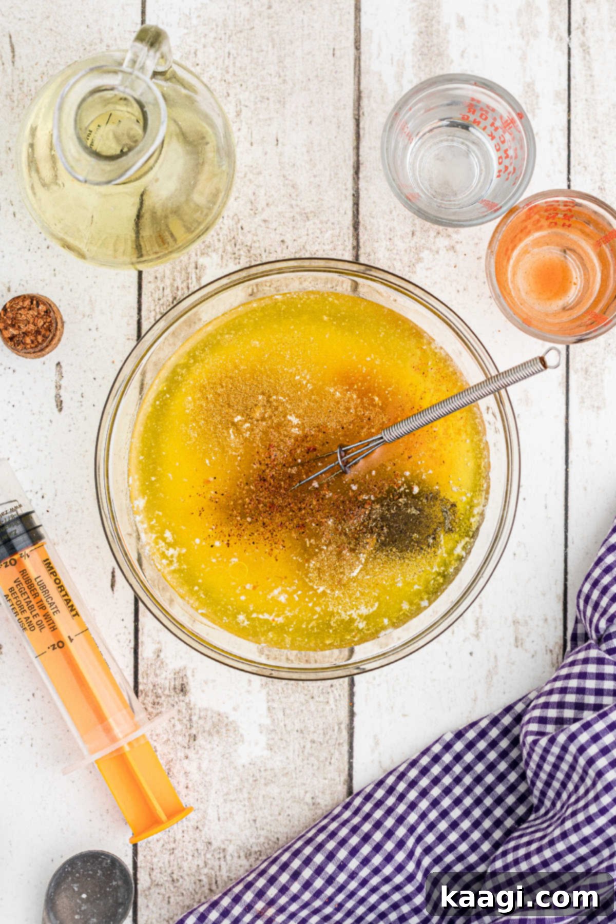 Cajun Spice Injection for Unforgettable Turkey Flavor 4 A small mixing bowl with melted butter, olive oil, hot sauce and other seasonings.