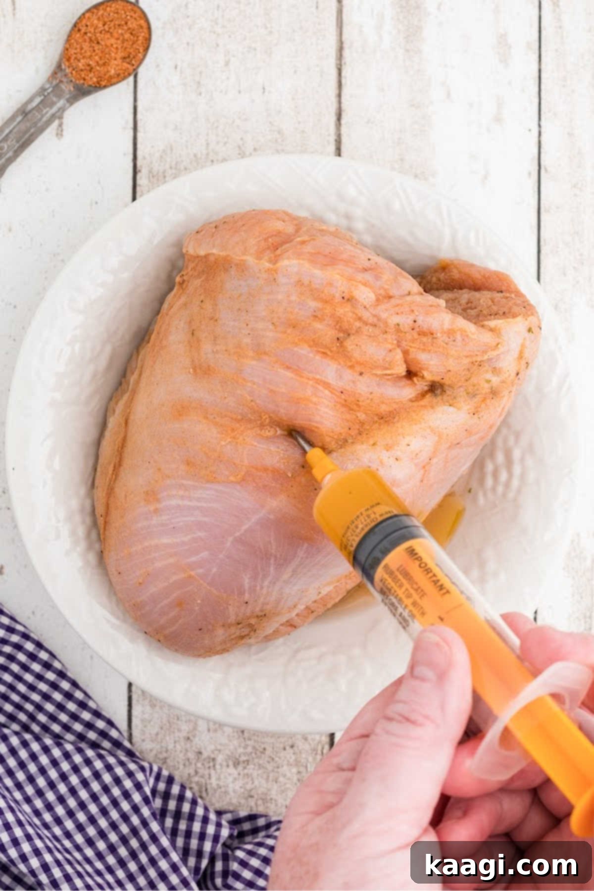 Cajun Spice Injection for Unforgettable Turkey Flavor 5 Marinade being injected into a turkey breast.