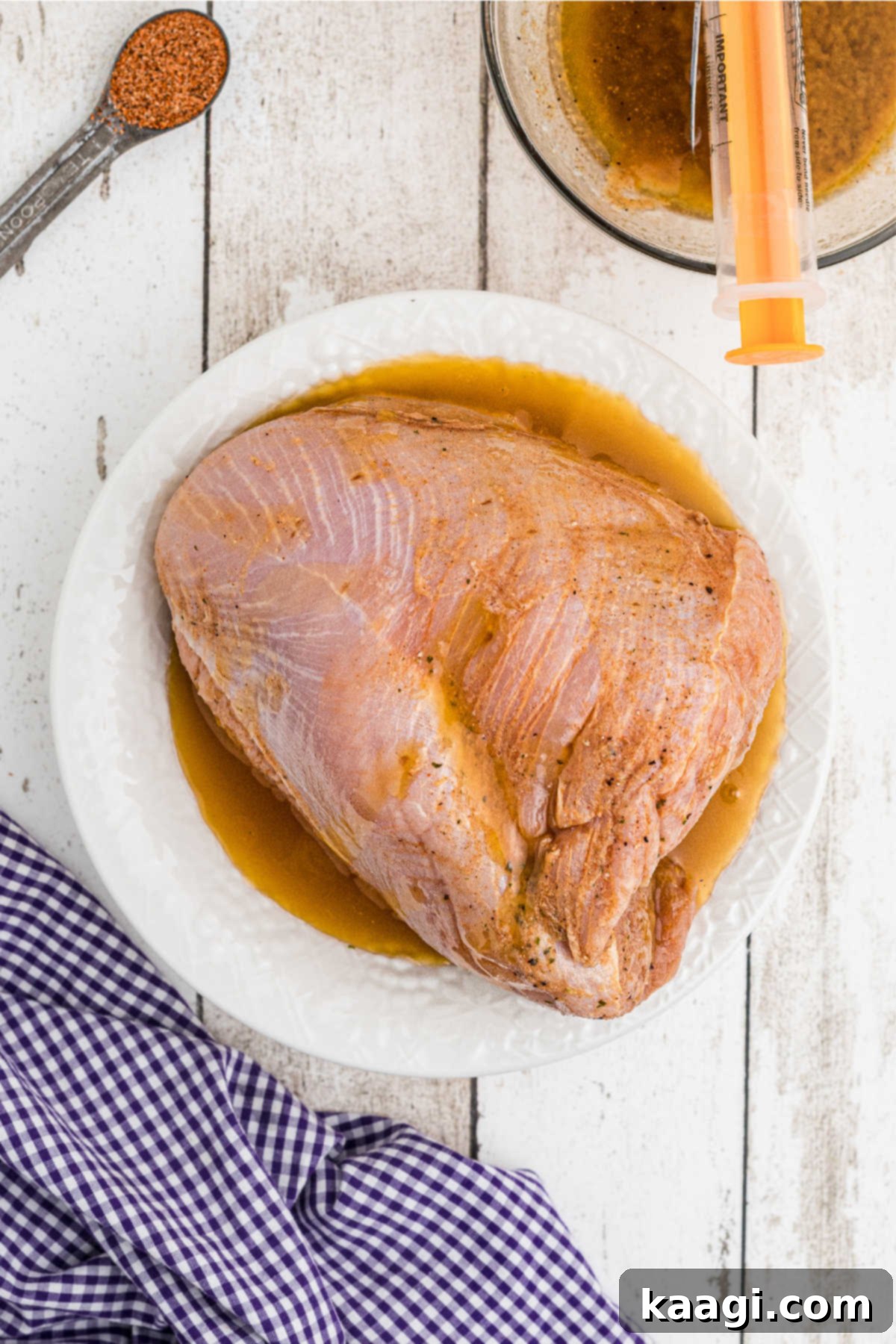Cajun Spice Injection for Unforgettable Turkey Flavor 6 A turkey breast sitting in a marinade.