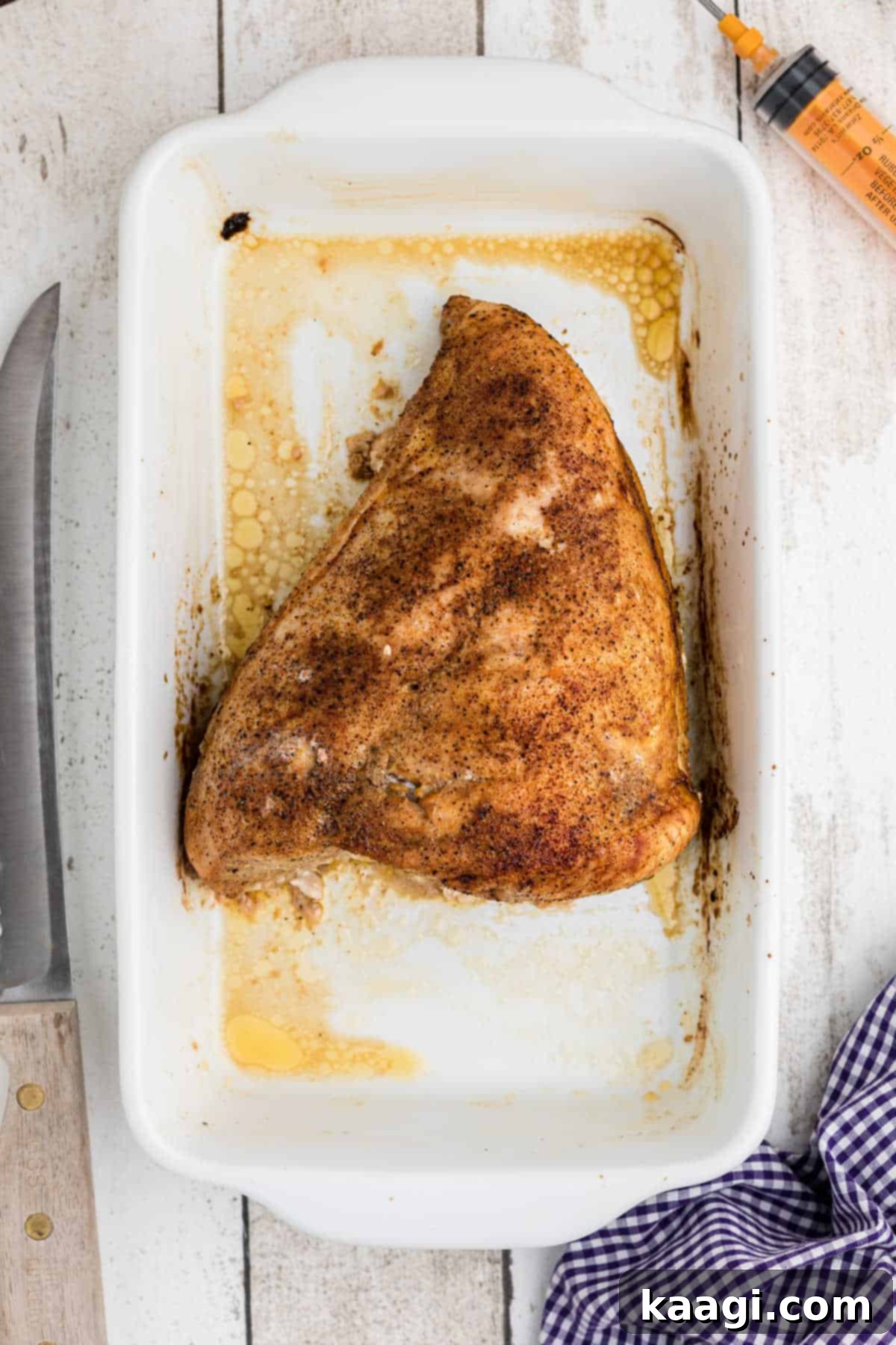 Cajun Spice Injection for Unforgettable Turkey Flavor 8 A cooked and seasoned turkey breast in a baking dish.