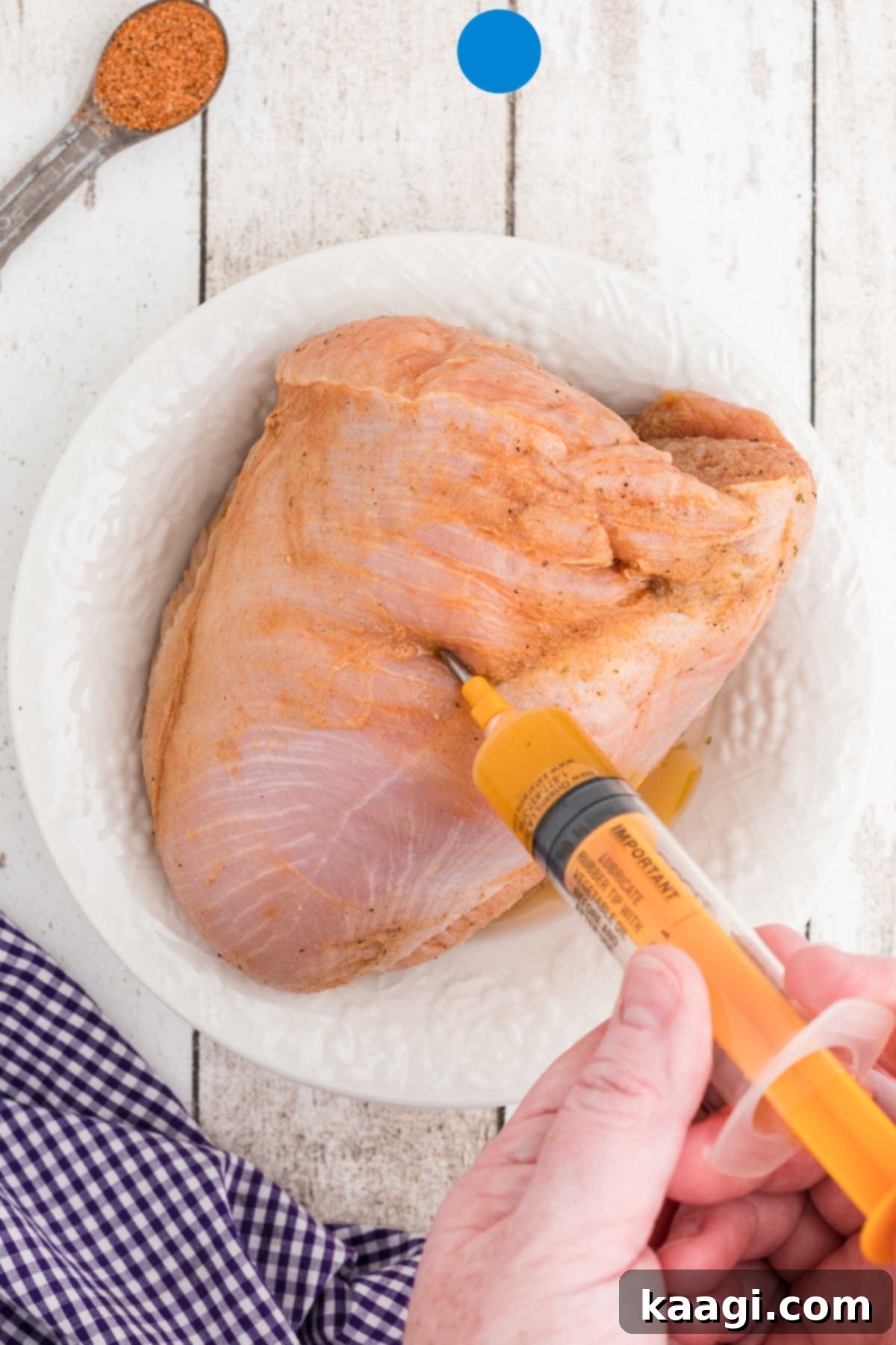A turkey breast being injected with a marinade.