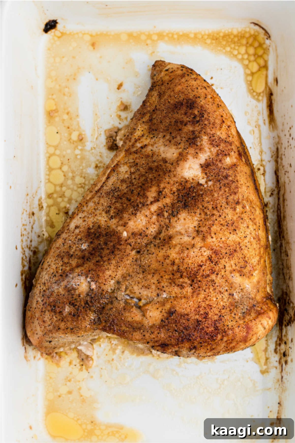 A cooked turkey breast in a dish.