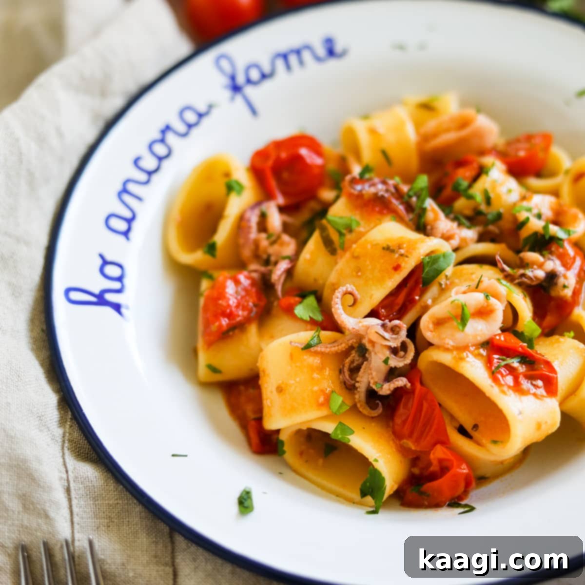 Calamarata (Calamari and Tomato Sauce Pasta) served in a deep bowl.