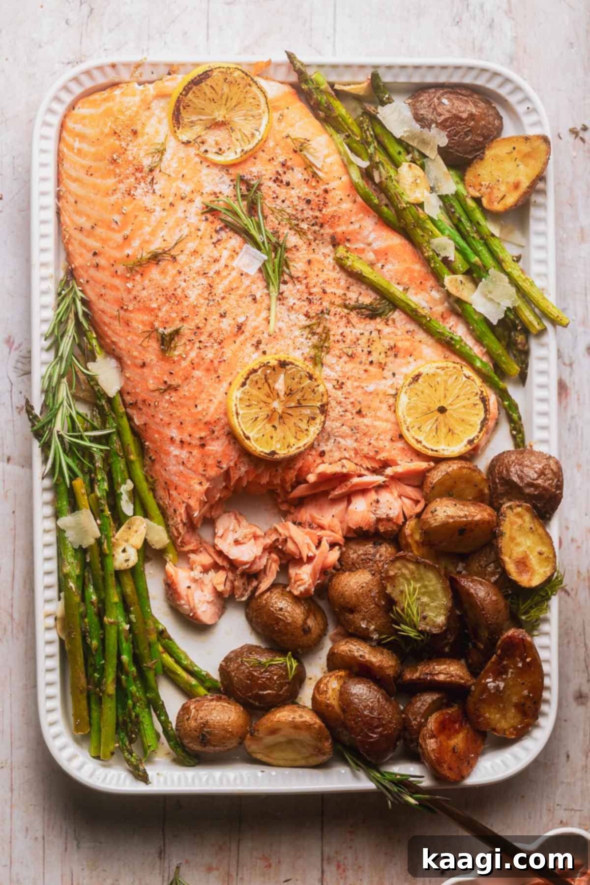 Sheet Pan Lemony Brown Butter Salmon Dinner with crispy roast potatoes and tender asparagus spears.