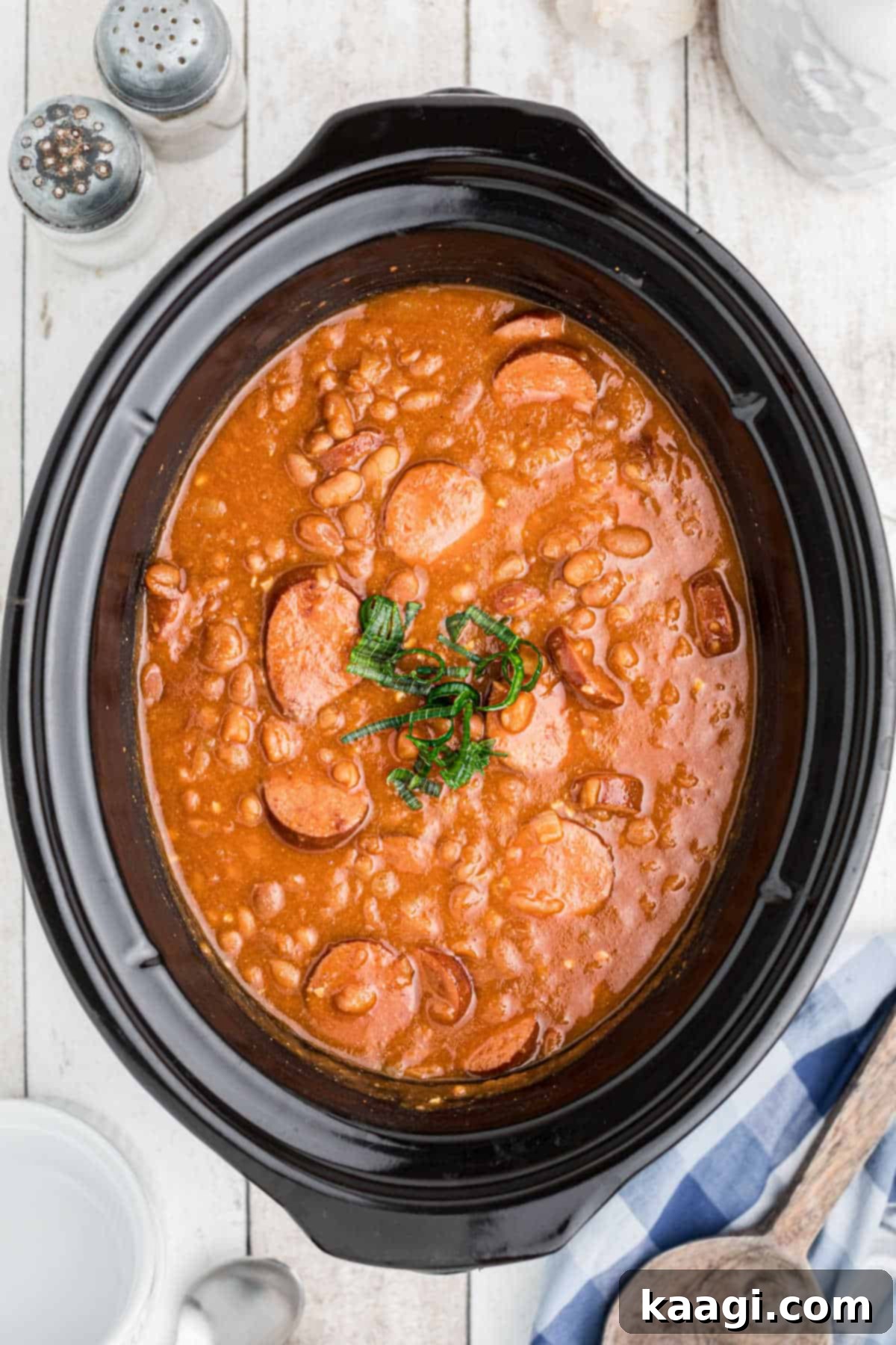 Smoky Kielbasa and Sweet Baked Beans Slow Cooker Delight 2 Overhead shot of a slow cooker filled with kielbasa and baked beans, ready to be served.