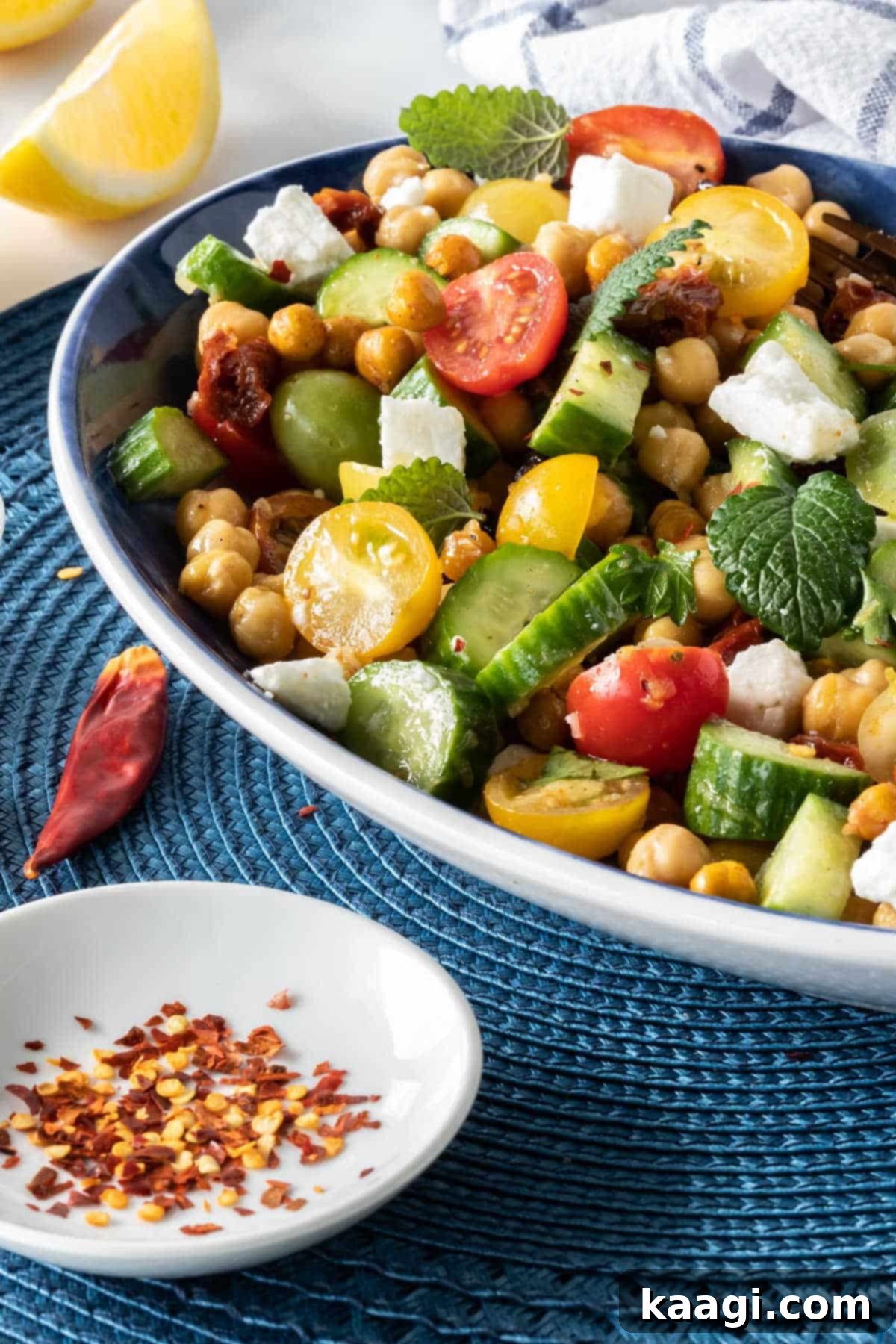A plate featuring crispy chicken and waffles, thoughtfully accompanied by a vibrant side of grilled vegetables and a fresh salad, illustrating a complete meal.