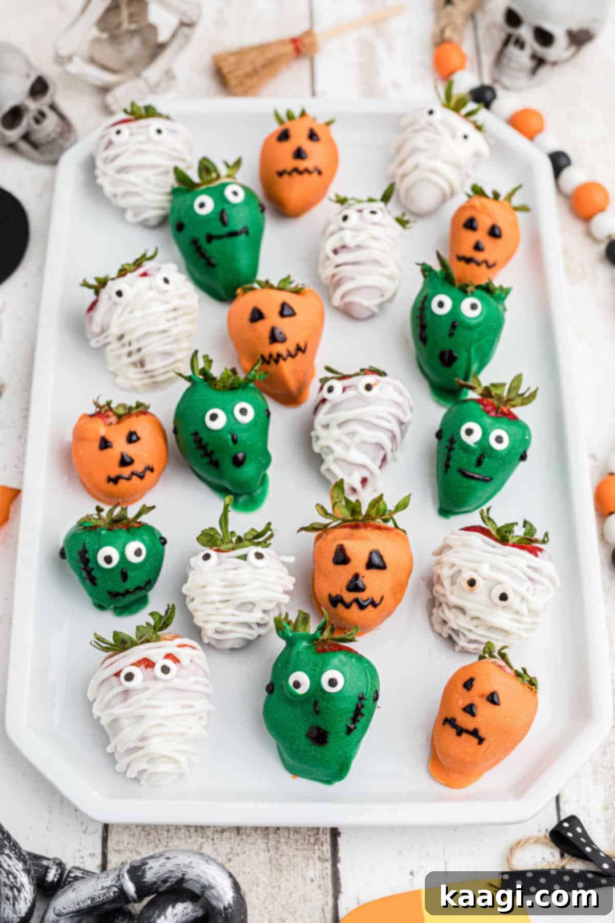 A festive plate of assorted Halloween themed chocolate covered strawberries.