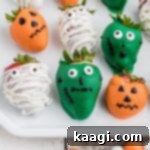 Close up shot of some Halloween chocolate covered strawberries, highlighting the festive designs.