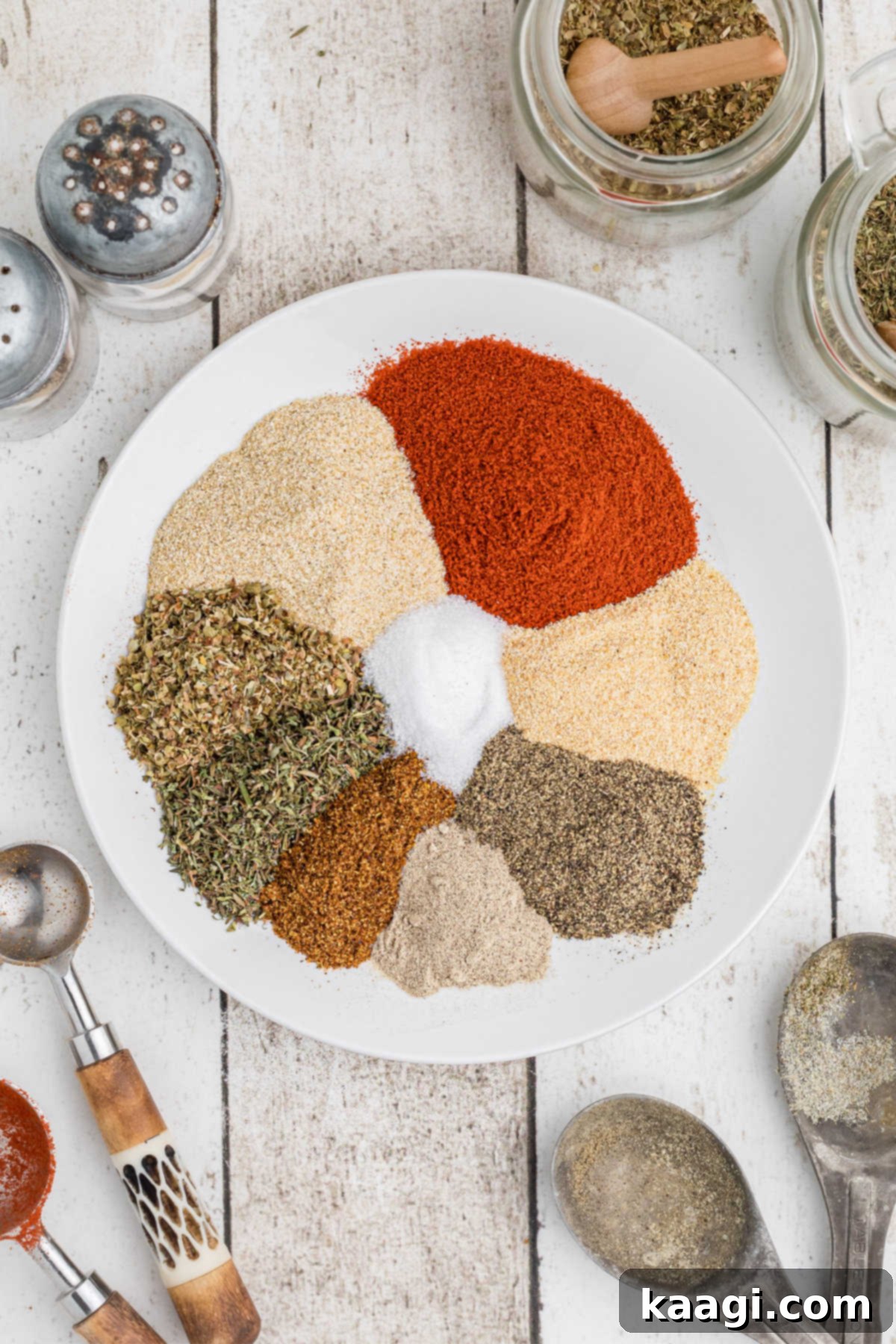 A neatly arranged circle of vibrant Cajun Two Step seasonings, ready to be mixed, showcasing the rich colors of paprika, herbs, and peppers.