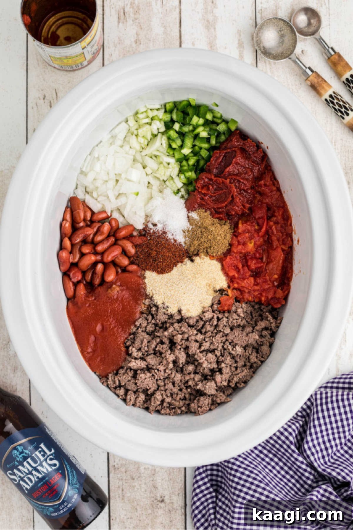 All the ingredients for the slow cooker beer chili loaded into the slow cooker pot, ready for cooking.