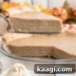 Close up of a slice of white pumpkin pie being taken out of a pie dish.
