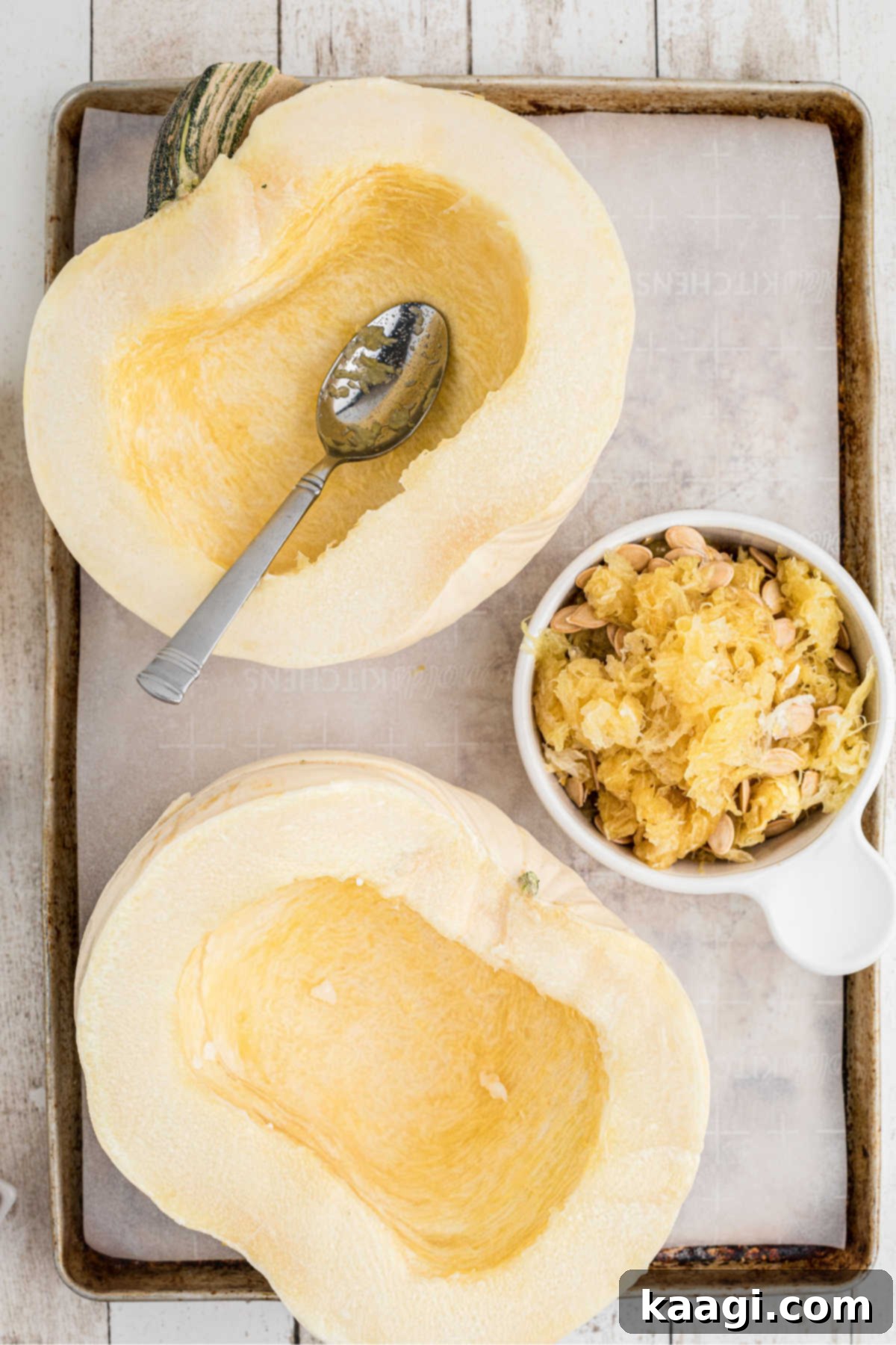 A white pumpkin cut in half and the seeds scooped out.