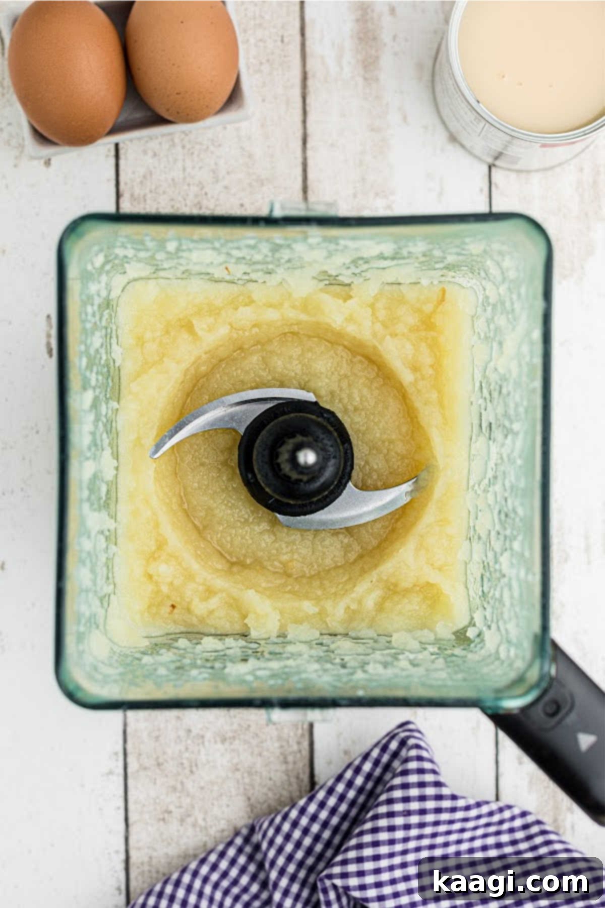 A food processor with white pumpkin flesh processed.