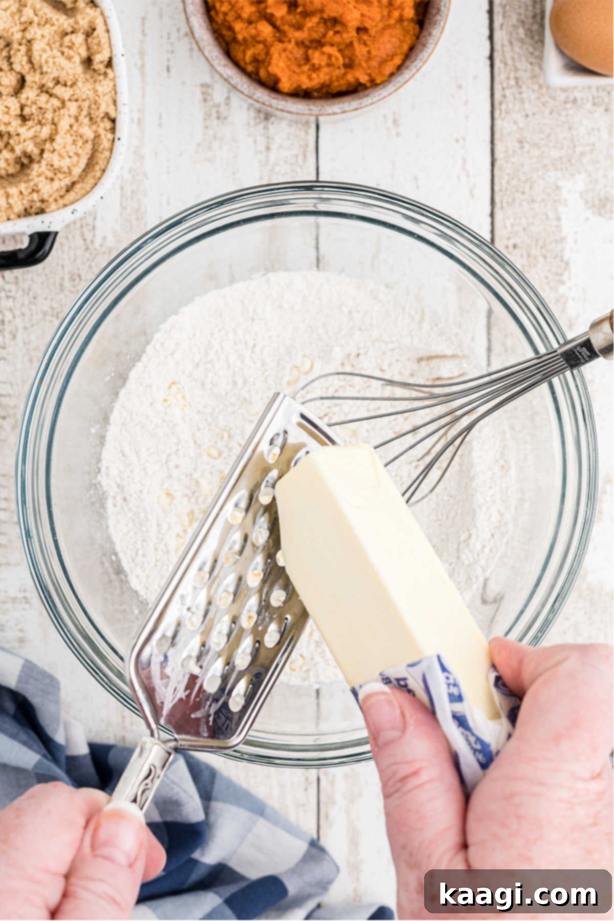 Butter being grated into a flour mixture.