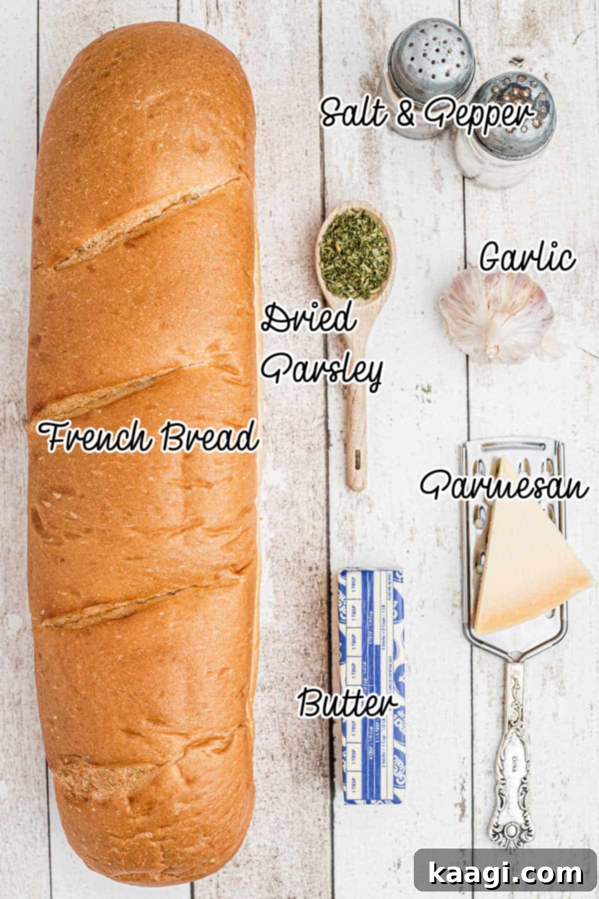 Stuffed garlic bread ingredients laid out on a wooden surface with text overlay, showing fresh garlic, butter, parmesan, parsley, salt, pepper, and a French bread loaf.