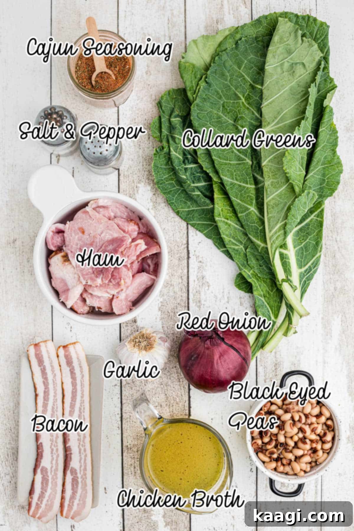 Ingredients laid out on a wooden table, including bacon, onions, garlic, collard greens, ham, chicken broth, and black eyed peas.